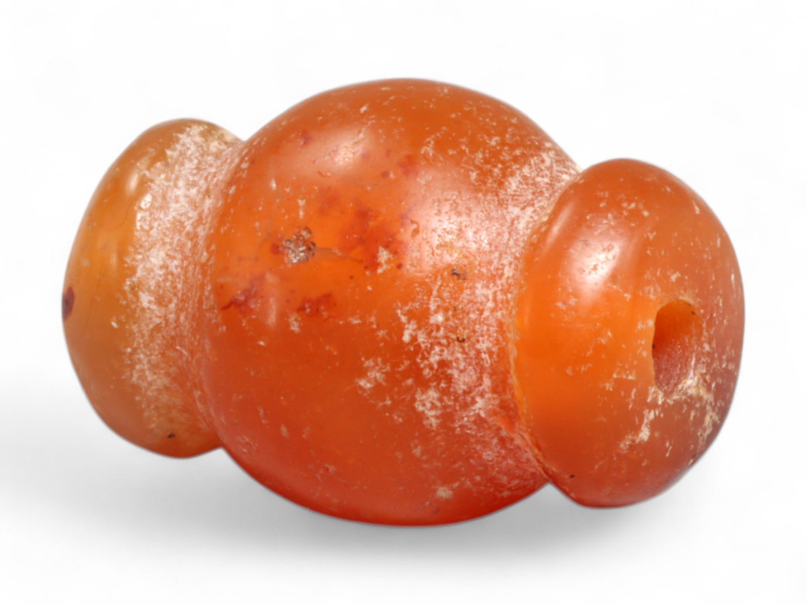 Ancient Medieval Chola Collared Carnelian Trade Bead, c. 9th-13th Century CE, 2cm, 5g: This finely polished carnelian bead, carved in a classic collared form, originates from the powerful Chola Dynasty of South India, a civilization that thrived between the 9th and 13th centuries CE. Th