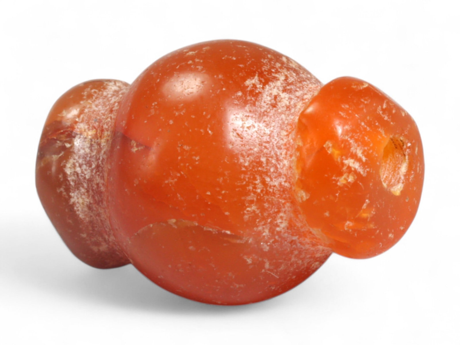 Ancient Medieval Chola Collared Carnelian Trade Bead, c. 9th-13th Century CE, 2cm, 5g: This finely polished carnelian bead, carved in a classic collared form, originates from the powerful Chola Dynasty of South India, a civilization that thrived between the 9th and 13th centuries CE. Th