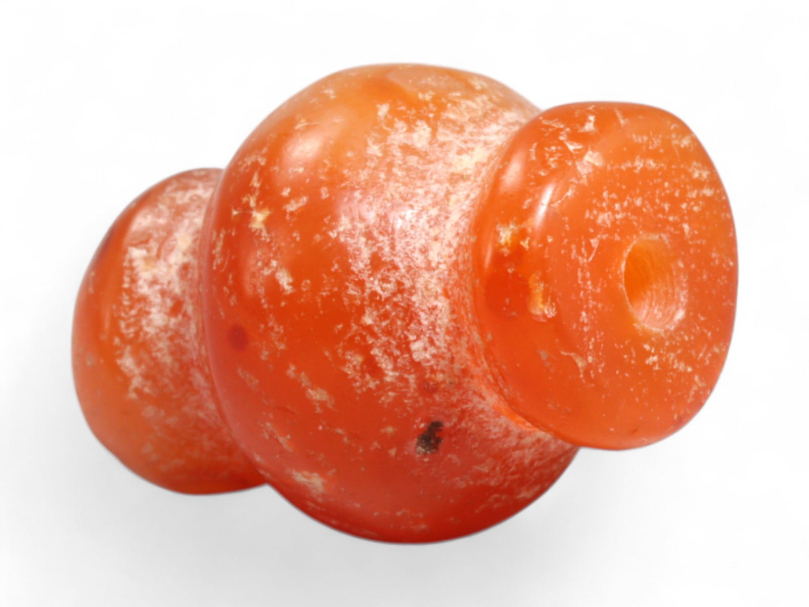 Ancient Medieval Chola Collared Carnelian Trade Bead, c. 9th-13th Century CE, 1.8cm, 4g: This finely polished carnelian bead, carved in a classic collared form, originates from the powerful Chola Dynasty of South India, a civilization that thrived between the 9th and 13th centuries CE. Th