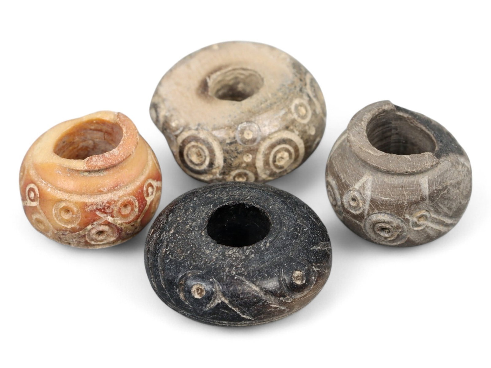 Ancient Mesopotamian Grooved Bone Spindle Whorl Set, c. 2000-1600 BCE, 0.8-1.5cm, 5g: This compelling set of four ribbed bone spindle whorls hails from the heart of ancient Mesopotamia, where textile production was both a domestic necessity and a cornerstone of temple economies. Dated 