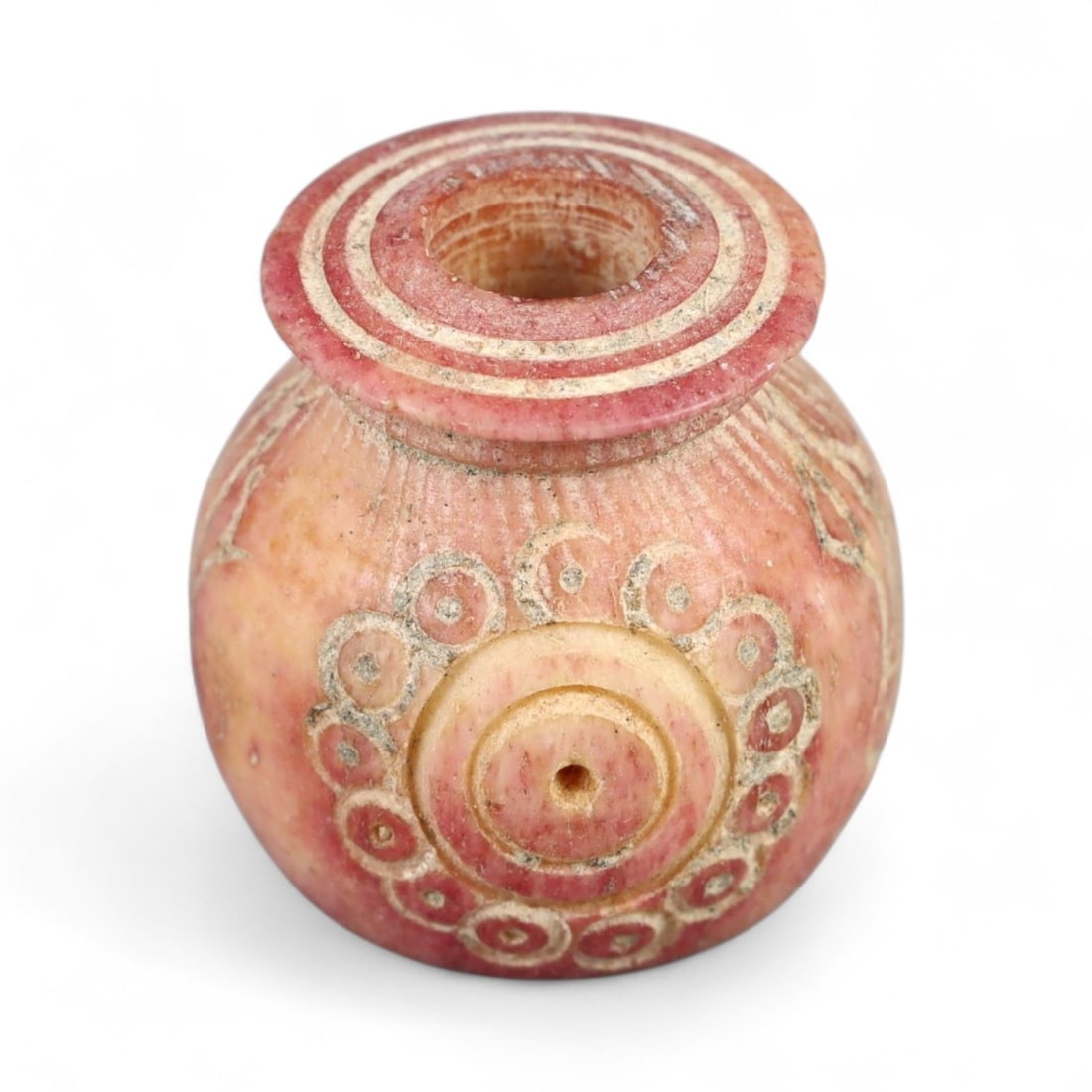 Ancient Indo-Greek Radiant Rosette Sun Symbol Spindle Whorl, c. 2nd-1st Century BCE, 1.4cm, 2.9g: This remarkable spindle whorl, carved from a pink-hued stone with exceptional delicacy and geometric precision, originates from the culturally rich Indo-Greek period in Northern India and Afghanistan.