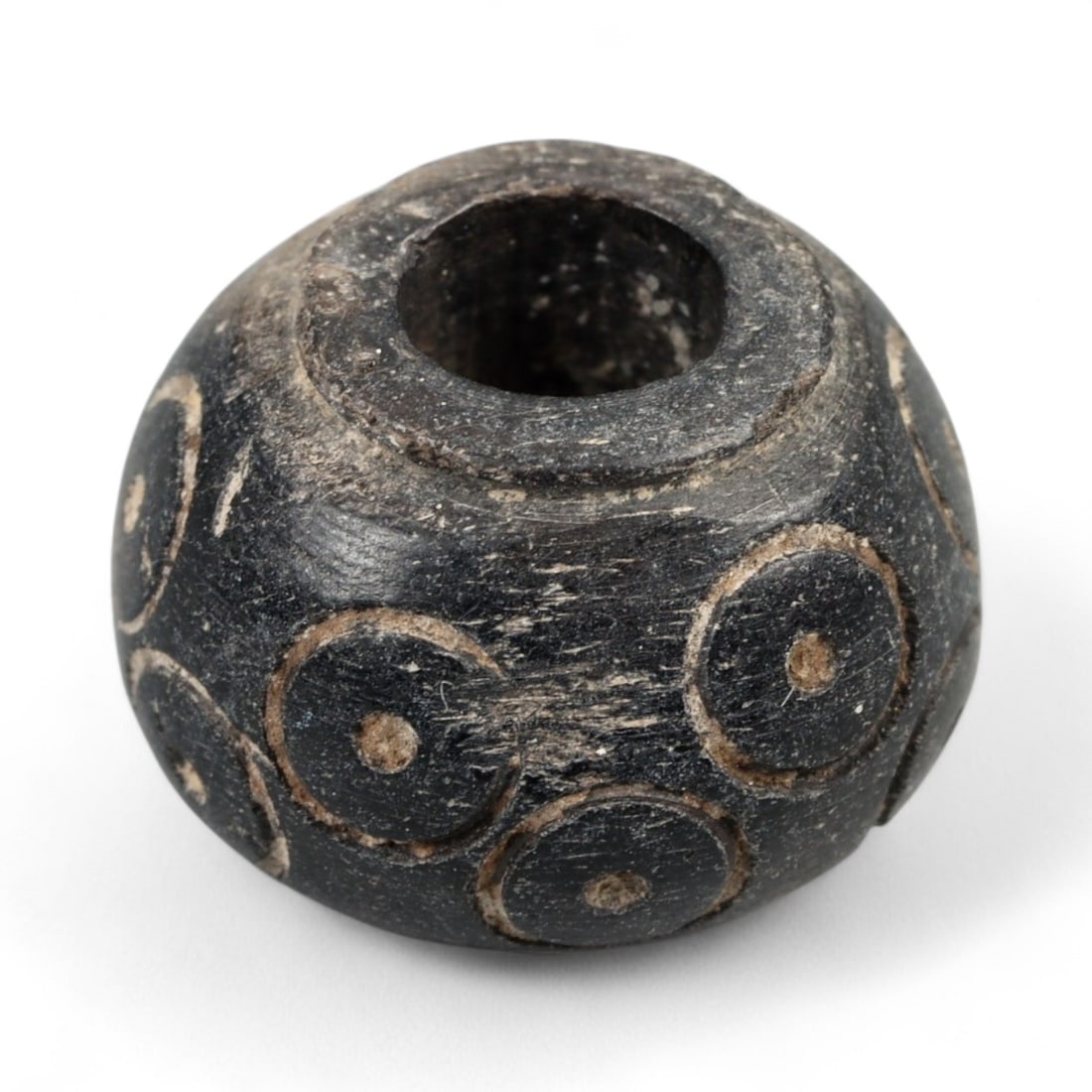 Ancient Bactrian Dot Motif Black Stone Spindle Whorl, c. 3rd-2nd Millennium BCE, 1cm, 1.9g: This rare and visually arresting spindle whorl originates from the Bactrian region of Central Asia, an ancient cultural crossroads renowned for its advanced craftsmanship and symbolic artistry during 
