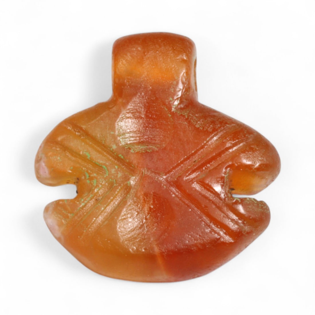 Ancient Coptic Egyptian Cross-Hatched Robe-Form Carnelian Amulet, c. 6th-8th Century CE, 1.79g: This beautifully carved amulet from Coptic Egypt, dating to the 6th-8th century CE, showcases a bold robe-like form with deeply incised cross-hatching that forms an 'X' across the body. Likely symboli