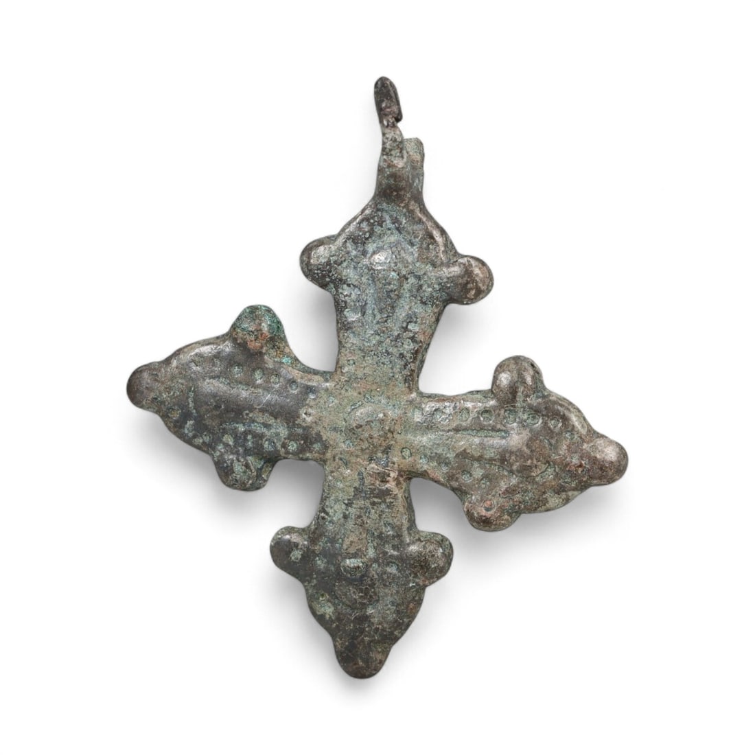 Ancient Kievan Rus Fleur-de-Lis Bronze Cross Pendant, c. 11th-13th Century CE, 1.5g: This elegant bronze cross pendant, adorned with ornate fleur-de-lis finials at the end of each arm, is a refined example of high medieval Christian artistry in the Kievan Rus. Dating from the 11th-13t