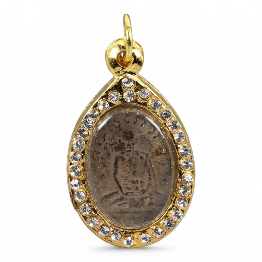 Vintage Thai Monk Amulet in Jeweled Teardrop Gold Case, late 20th Century, 29g: This vintage Thai amulet features a solemn depiction of a revered Buddhist monk seated in meditative posture, surrounded by sacred script in faint yet discernible detail. Cast in darkened clay or comp