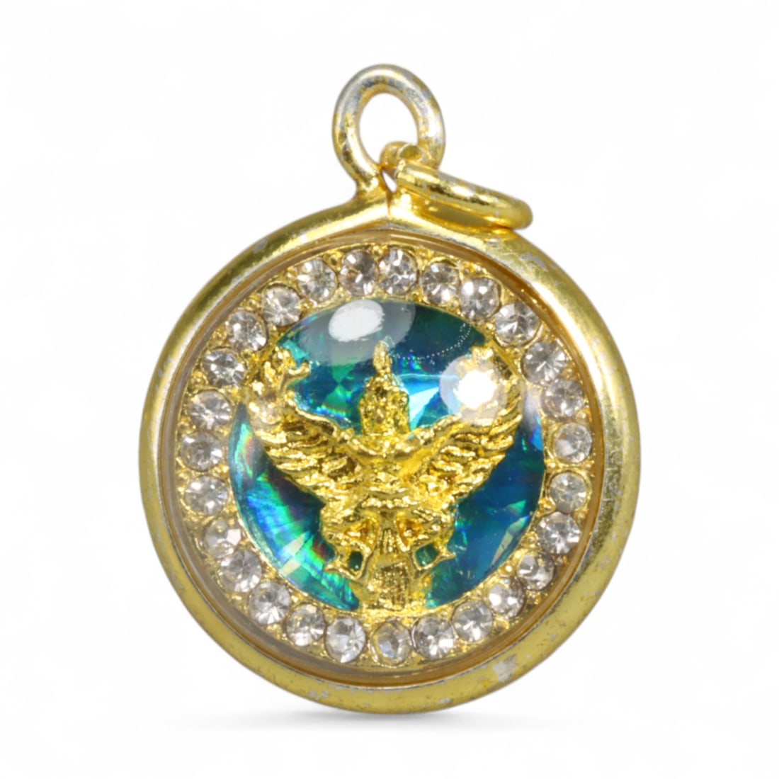 Thai Royal Garuda Emblem Gold Glass Amulet Pendant, Contemporary Buddhist Era, 4g: Radiating power and protection, this radiant Thai amulet pendant showcases the majestic Garuda - the mythical bird-man mount of Vishnu and the national emblem of Thailand - rendered in high-relief gol