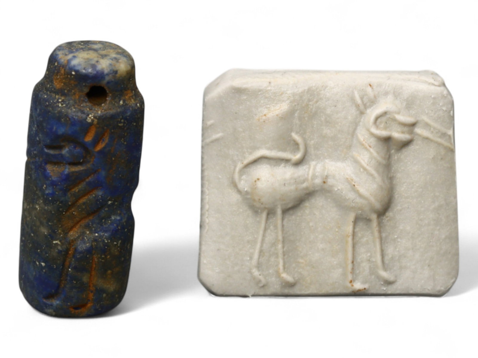 Ancient Akkadian Lapis Lazuli Cylinder Seal of Standing Ibex, c. 2350-2150 BCE, 3.7g: This exquisite cylinder seal, carved from deep blue lapis lazuli, originates from the Akkadian Empire, c. 2350-2150 BCE. Measuring 0.9 x 2 cm and weighing 3.7 grams, the piece is small enough to be wo