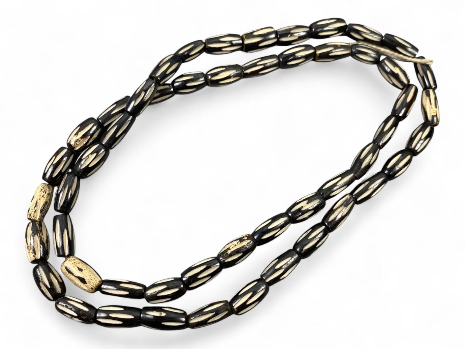 Vintage Tibetan Ethnic Pattern Bone Beads Strand, Unstrung, c. Mid-20th Century CE, 28g: This vintage strand of Tibetan bone beads captures the enduring aesthetic and symbolic traditions of Himalayan artisanship. Carved from ethically sourced bone and left unstrung for customizable use, e