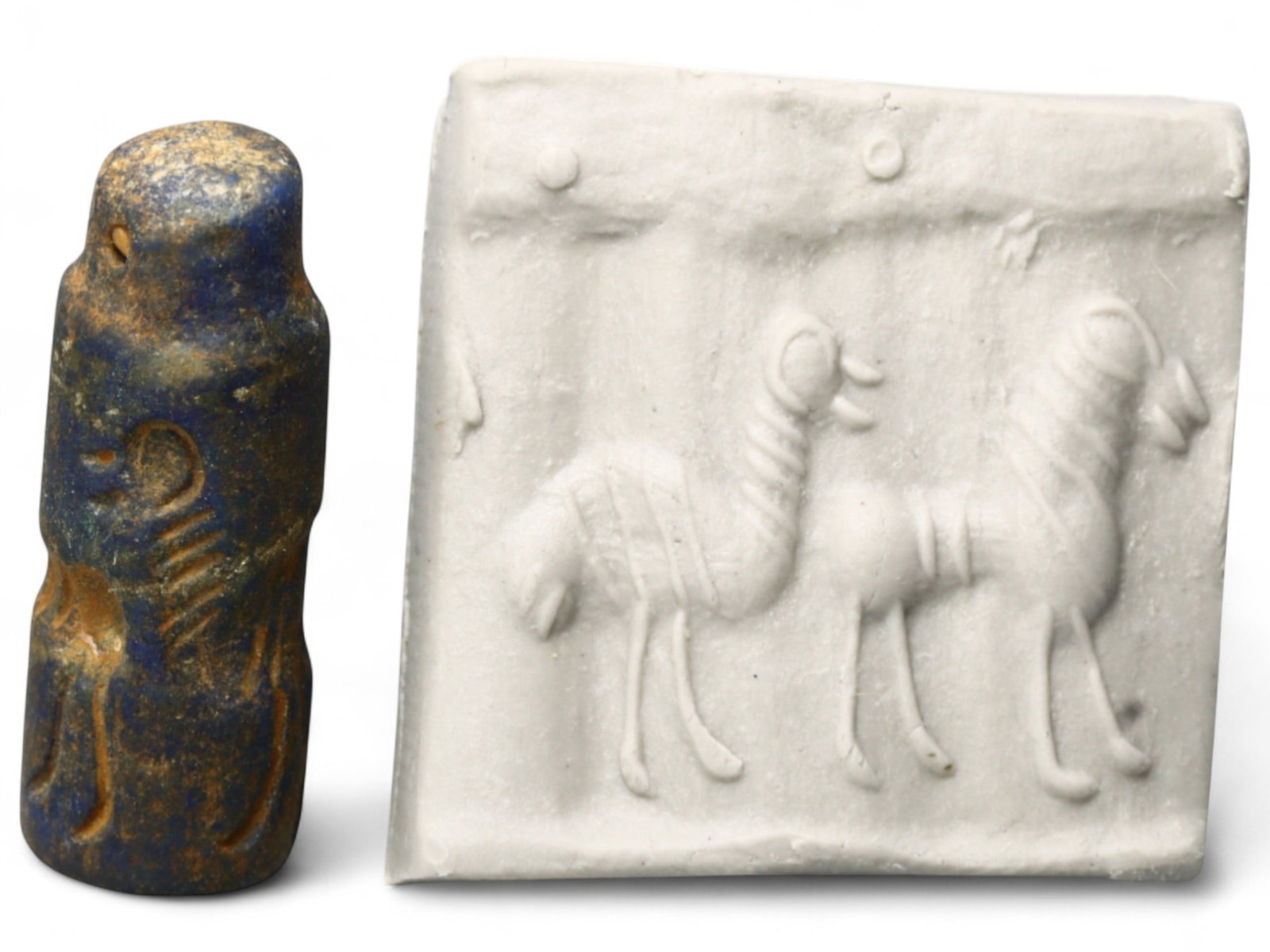 Ancient Akkadian Twin Celestial-Beast Lapis Lazuli Cylinder Seal, c. 2350-2150 BCE, 5g: This finely carved lapis lazuli cylinder seal presents a striking scene of twin long-necked beasts beneath a celestial register-an emblematic motif from the Akkadian Empire, circa 2350-2150 BCE. The c