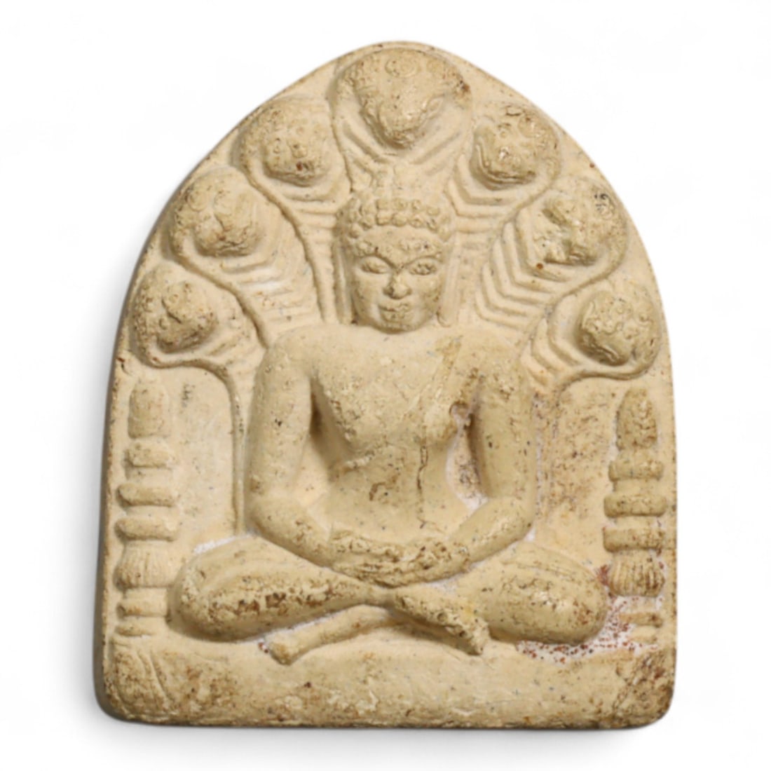 Vintage Thai Naga-Protected Buddha White Clay Amulet, c. Mid 20th Century CE, 7g: This vintage Thai amulet presents the Buddha seated in deep meditation beneath the protective canopy of the seven-headed Naga serpent, an iconic image rooted in Theravada and Mahayana Buddhist traditi