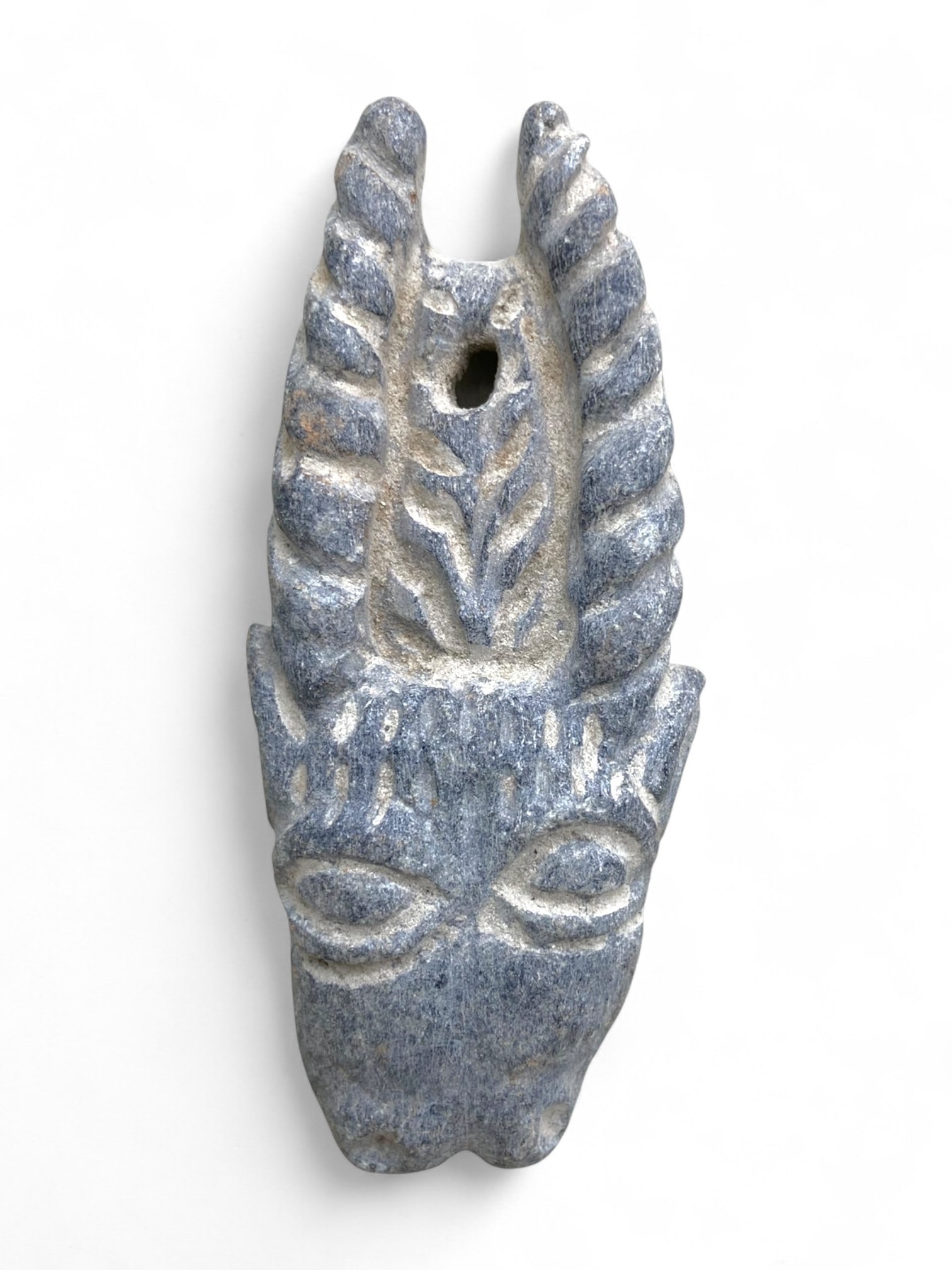 Ancient Jiroft Horned Deity Schist Amulet Pendant, c. 3rd Millennium BCE, 50g: This rare and powerfully carved amulet originates from the ancient Jiroft culture of southeastern Iran, dating to the 3rd millennium BCE. Sculpted in dark bluish-gray schist, it depicts a horned anthr