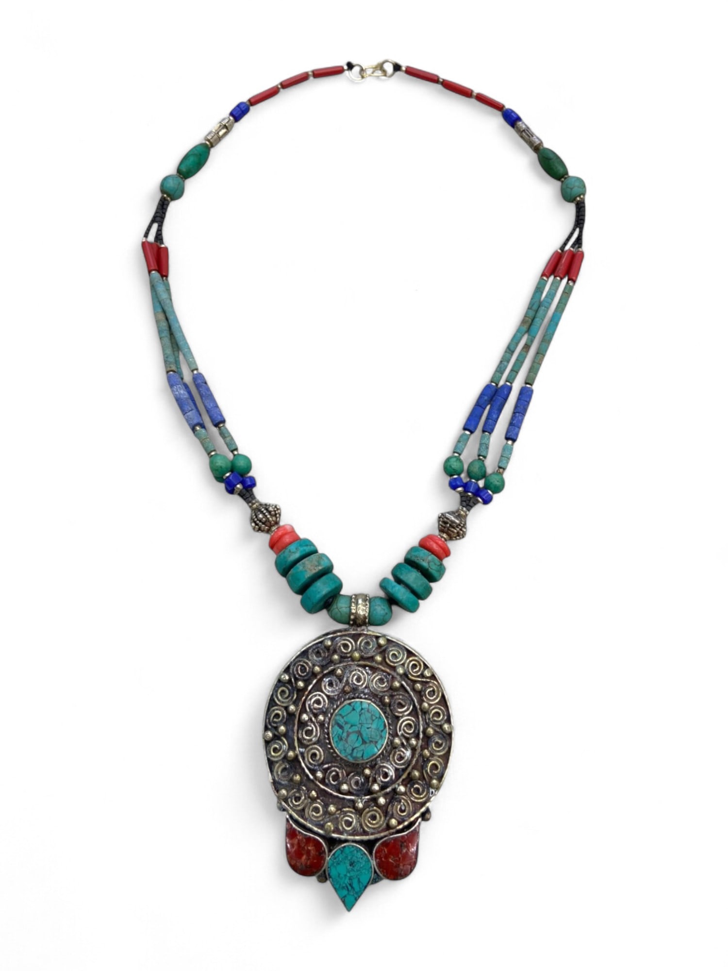 Central Asian Turquoise Spiral Medallion Necklace with Coral Accents and Layered Beads, 70g: This richly textured Central Asian necklace blends traditional symbolism with nomadic artistry, centered by a large medallion pendant inlaid with turquoise and framed in ornate spiral silverwork. The 