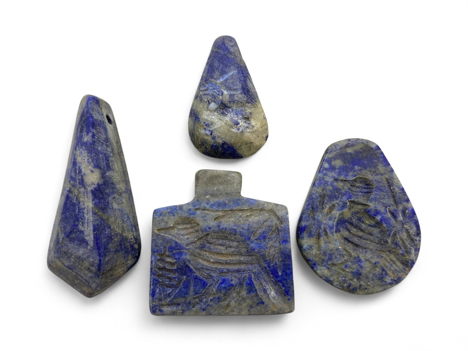 Ancient Bactrian Lapis Lazuli Amulet Set with Warrior and Animal Motifs, 3rd-2nd Millennium BCE, 77g: This stunning ensemble of four lapis lazuli amulets originates from the Bactrian region of Central Asia, dating to the 3rd-2nd millennium BCE, during the peak of lapis trade between ancient Afghanista