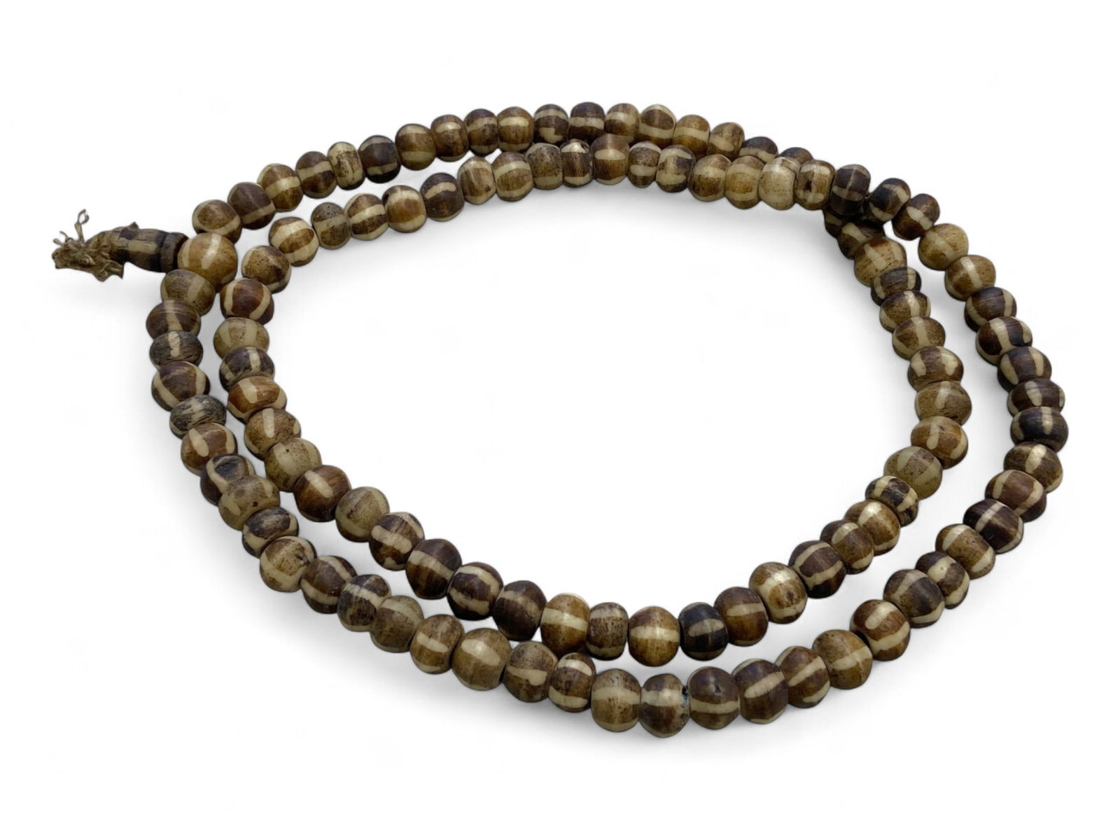 Ancient Himalayan Dzi-Inspired Banded Bone Prayer Beads Necklace, c. 10th-15th Century CE: This elegant strand of antique prayer beads originates from the Himalayan region, where Tibetan Buddhist communities crafted devotional tools with reverence and intention. Dating to approximately the