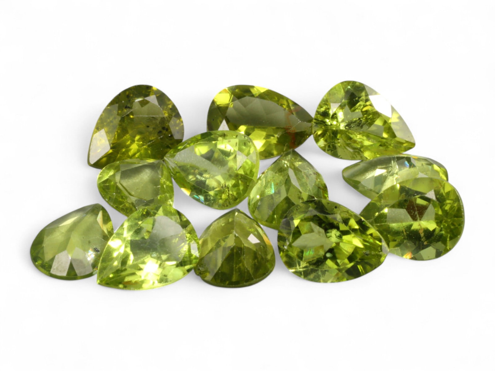 21.74 Carats Vivid Lime Green Peridot Pear Lot - Natural Pakistani Stones, 9-10mm: This eye-catching parcel of peridot dazzles with its lively lime-green hue and fine transparency, presented in beautifully cut pear shapes measuring approximately 9 to 10mm each. The stones sparkle wi