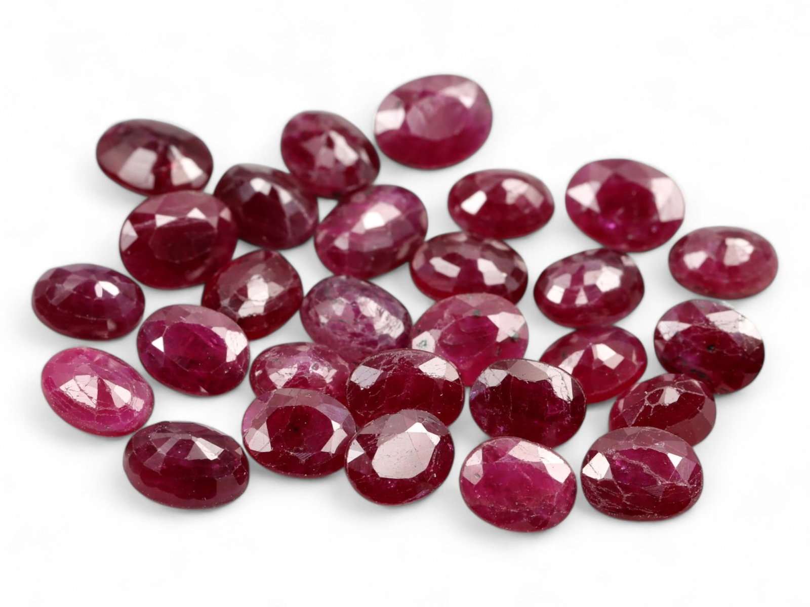 9.90 Carats Deep Red Ruby Oval Lot - Natural African Stones, 4.5mm: This well-matched parcel of oval-cut rubies features rich, deep red hues with vivid cherry and wine undertones. Measuring approximately 4.5mm each, the stones display bright flashes from mixed facetin