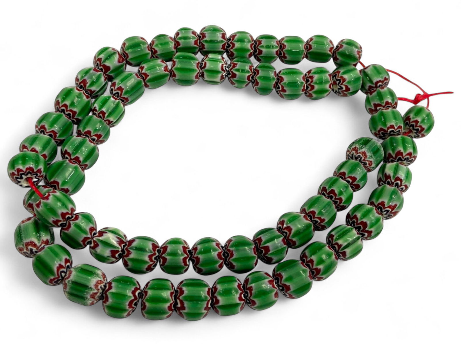 Antique Venetian Green Melon Chevron Trade Glass Beads Strand, African Market, c. 19th-20th Century: Radiating with bold color and rhythmic form, this strand of antique Venetian green chevron glass beads represents a harmonious blend of European artistry and African cultural significance. Produced in