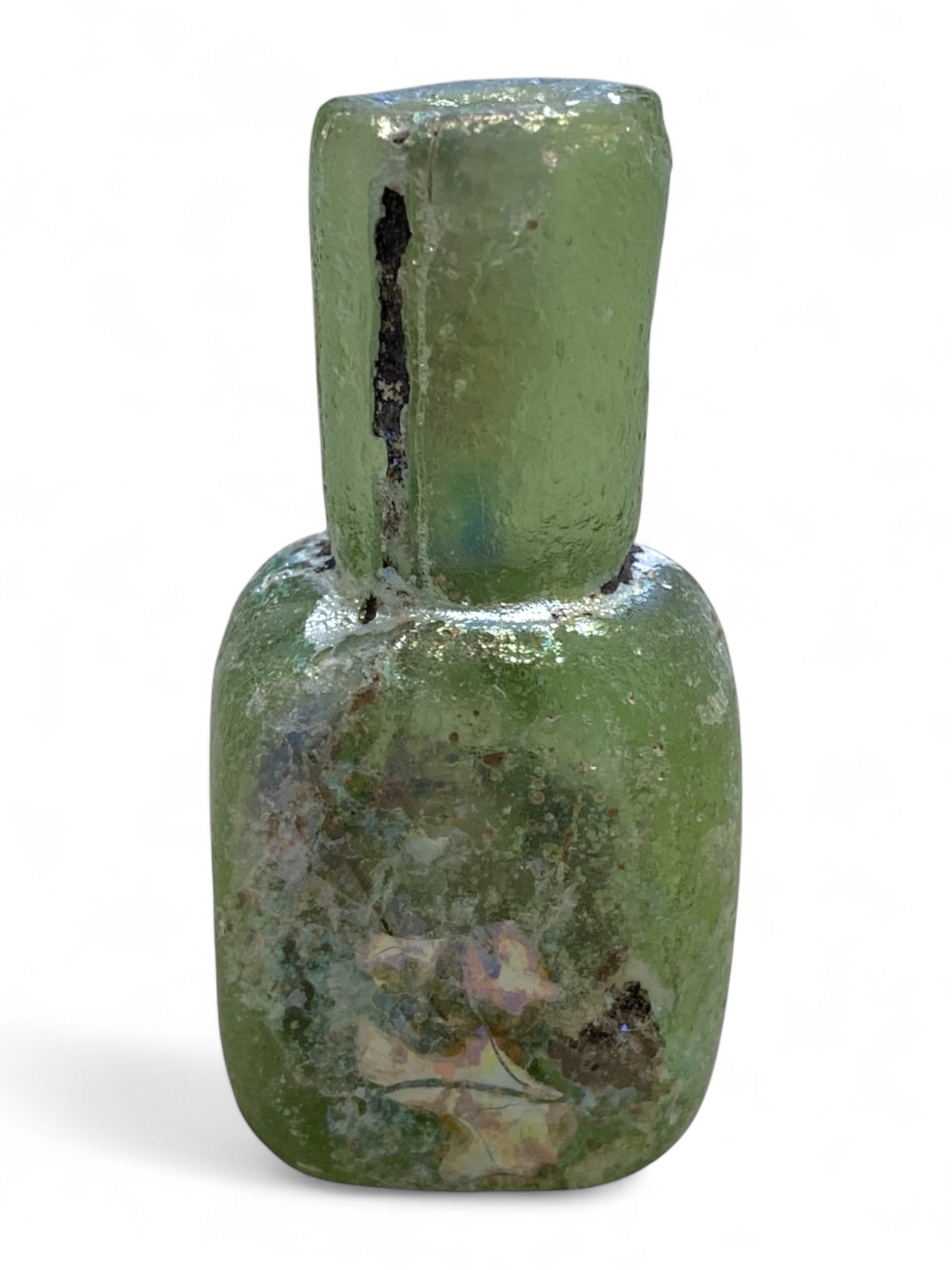 Ancient Roman Pale Green Rectilinear Glass Unguentarium, c. 1st-3rd Century CE, 30g: This distinctive Roman glass unguentarium, dating to the 1st-3rd century CE, stands out for its rare rectilinear form and soft pale green hue. Measuring approximately 5.5 cm in height and 2.5 cm in wi