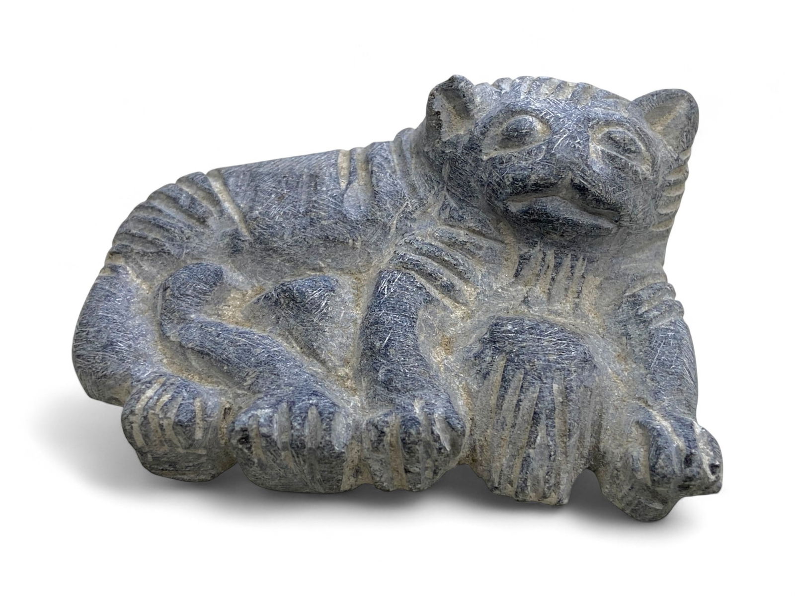 Ancient Near Eastern Reclining Feline Guardian in Steatite, c. 2nd-1st Millennium BCE, 86g: Carved from deep blue-gray steatite, this charming yet powerful figure of a reclining feline likely originates from the broader Near Eastern or Anatolian world during the late Bronze Age to early Iron