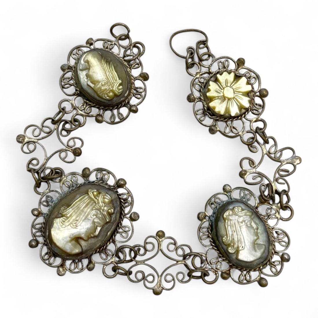 Antique Neoclassical Mother-of-Pearl Cameo Filigree Silver Bracelet, c. 19th Century CE, 12g: This elegant Neoclassical revival bracelet from the 19th century is a sophisticated homage to the grandeur of antiquity. Composed of finely wrought silver filigree links and set with shimmering mother
