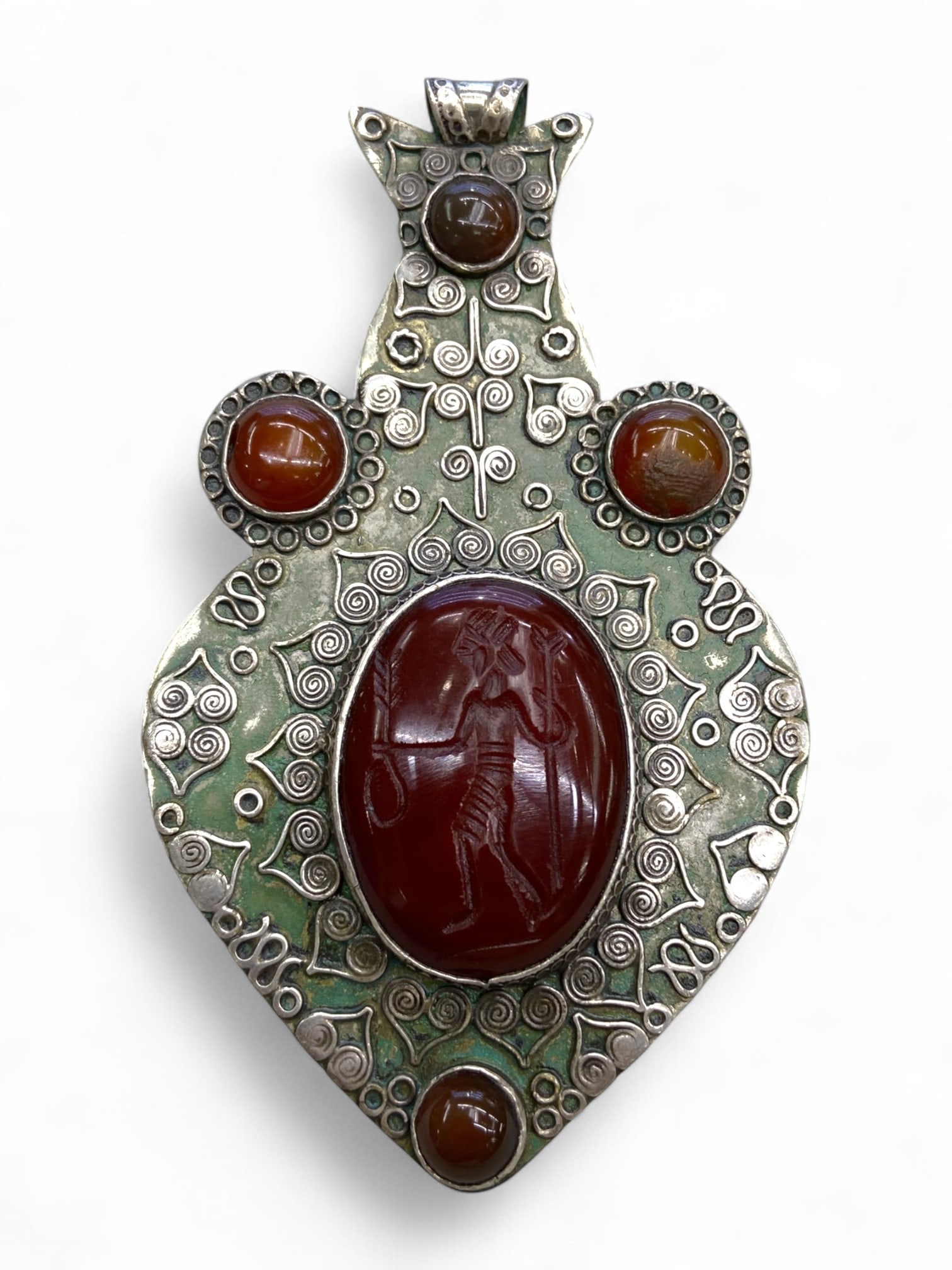 Antique Persianate Hero Intaglio Filigree Silver Alloy Pendant, c. 19th-Early 20th Century CE, 82g: This striking pendant captures the spirit of ancient Persian heroism reinterpreted through the lens of Qajar and early Pahlavi revivalist design. At its heart is a bold red carnelian intaglio depictin