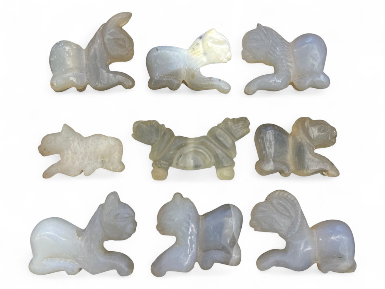 Ancient Medieval Silk Road Chalcedony Animal Amulet Set, c. 9th-13th Century CE, 64g: This graceful ensemble of nine carved animal amulets, rendered in pale translucent chalcedony and agate, originates from the culturally rich regions of the medieval Silk Road, dating approximately to 