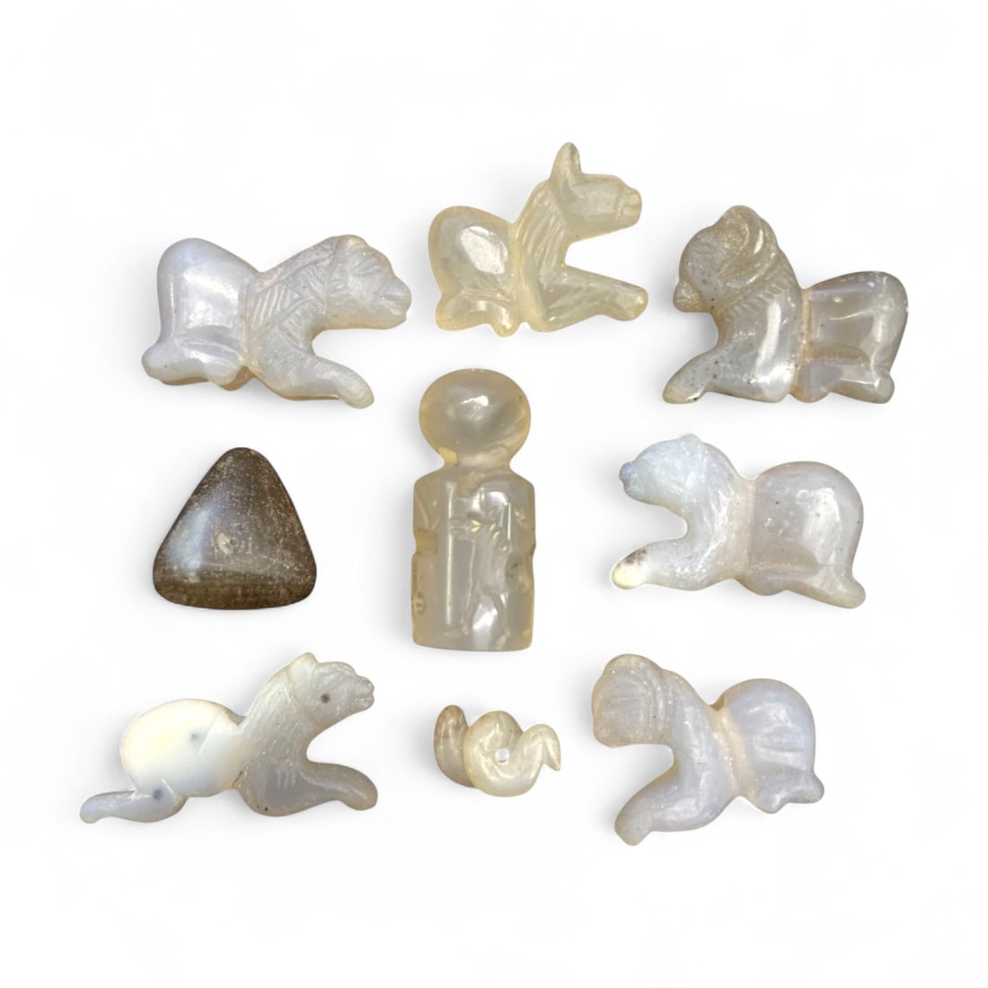 Ancient Medieval Silk Road Chalcedony Animal and Anthropomorphic Amulets c. 9th-13th Century CE, 63g: This luminous group of nine carved amulets in pale chalcedony and agate reflects the artistic and spiritual traditions of the medieval Silk Road, dating approximately to the 9th-13th century CE. Origi
