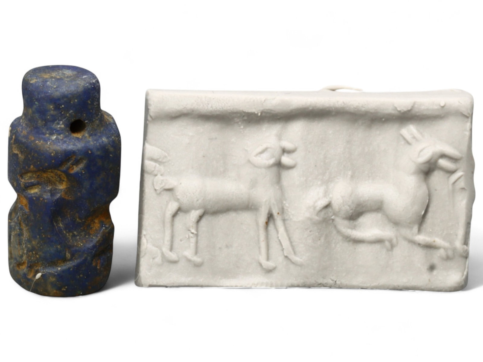 Ancient Akkadian Lapis Lazuli Cylinder Seal of Antelopes, c. 2350-2150 BCE, 6g: This striking lapis lazuli cylinder seal, dating to the Akkadian Empire (c. 2350-2150 BCE), depicts two finely carved antelopes, one standing in alert posture and the other in motion. Measuring 2 x 1 