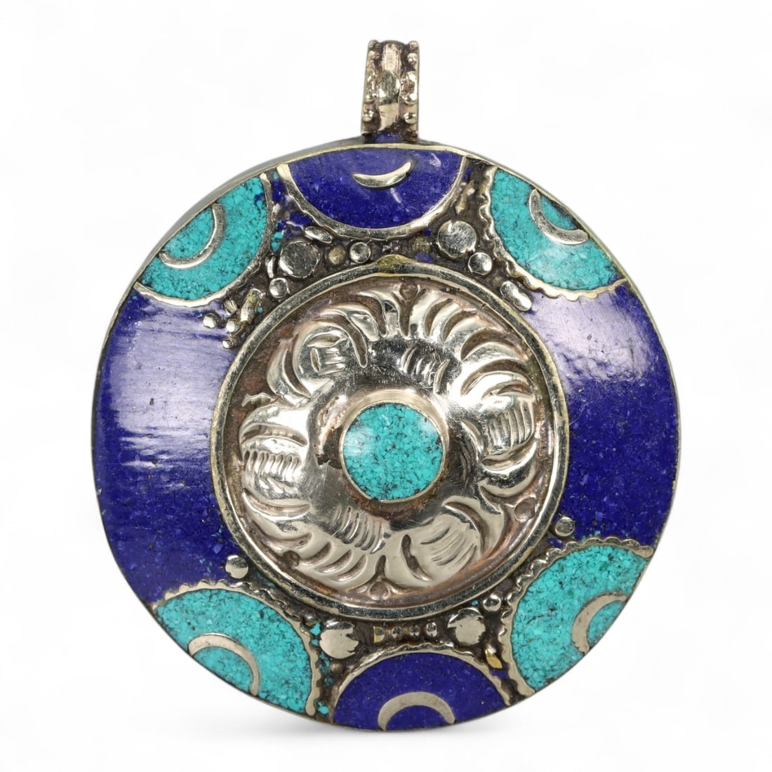 Tibetan Celestial Moon Phase Pendant with Turquoise Lapis Inlay, Silver Alloy, 42g: This visually arresting Tibetan pendant embraces a celestial theme, with lunar phase motifs encircling a radiant floral medallion. At the center lies a small turquoise cabochon, surrounded by a sculpt
