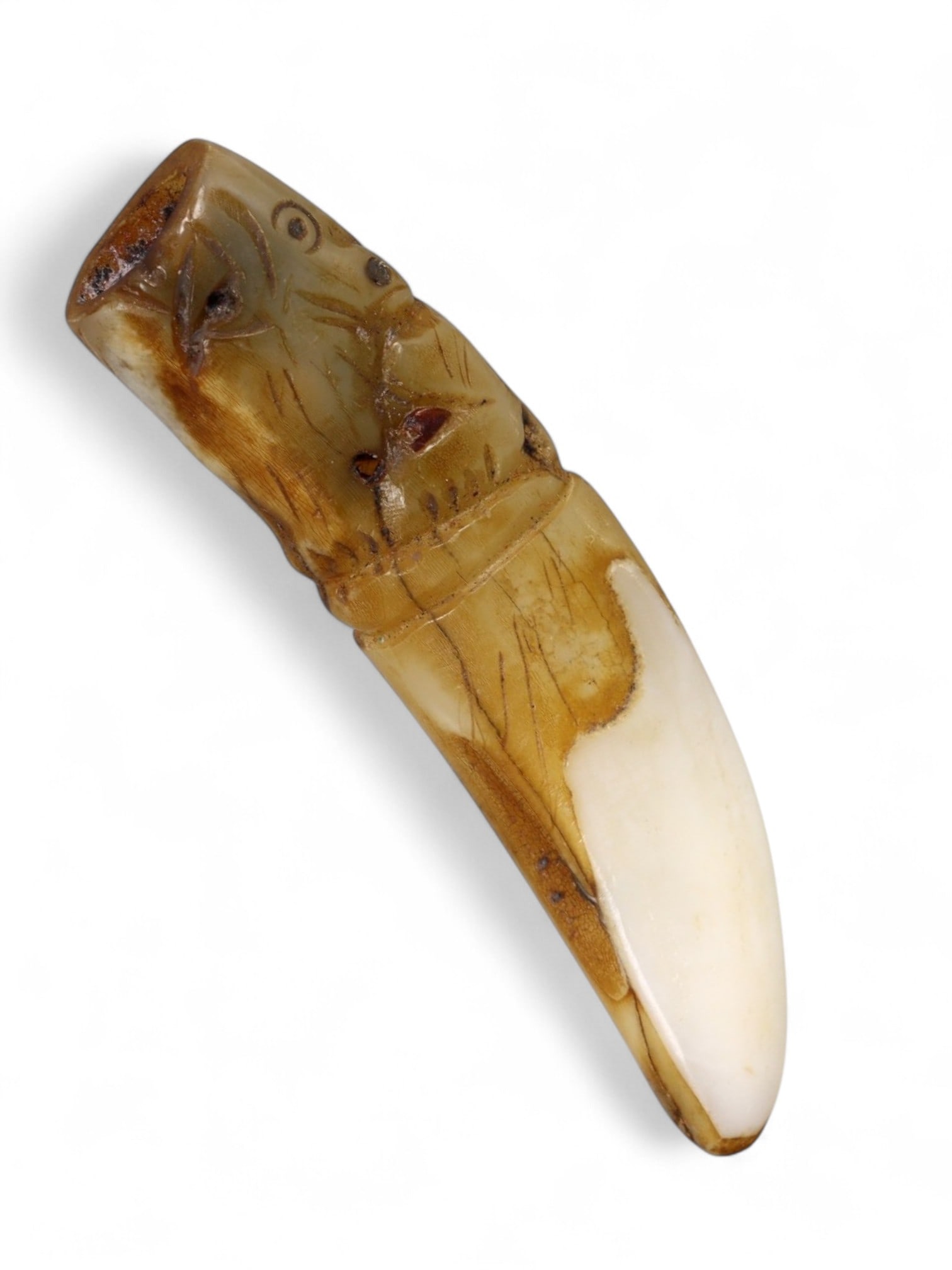 Antique Thai Tiger Fang Protective Wood Amulet, c. 19th-20th Century, 4g: This antique Thai amulet, carved in the form of a tiger fang, measures 5 x 1 cm and weighs 4 grams. The piece is skillfully crafted from natural wood and incised with a stylized tiger head at the top,