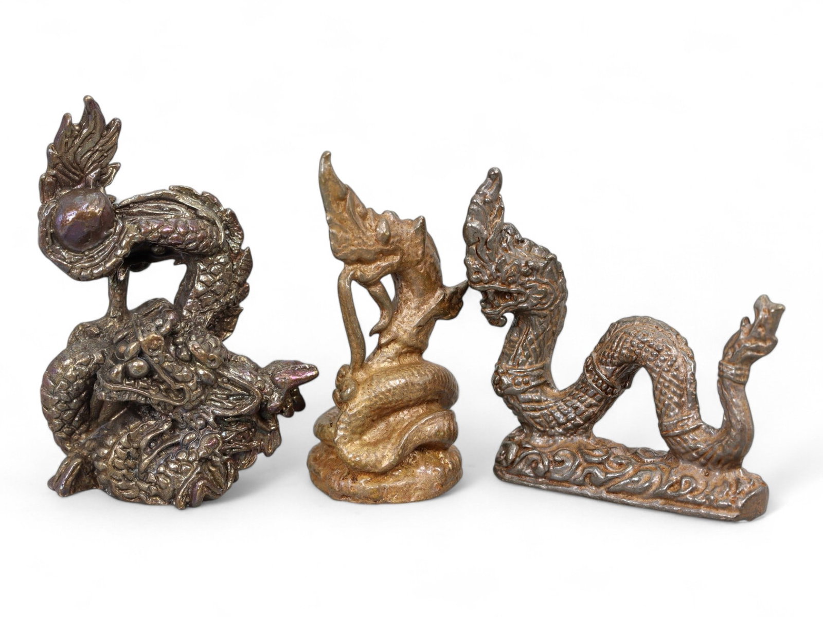 Antique Thai Mythical Dragon and Naga Serpent Bronze Amulet Trio, c. 19th-20th Century CE, 40g: This enchanting set of three bronze amulets showcases iconic creatures from Thai spiritual and mythological tradition - the dragon and the naga. These symbolic beings have long been revered in Southea