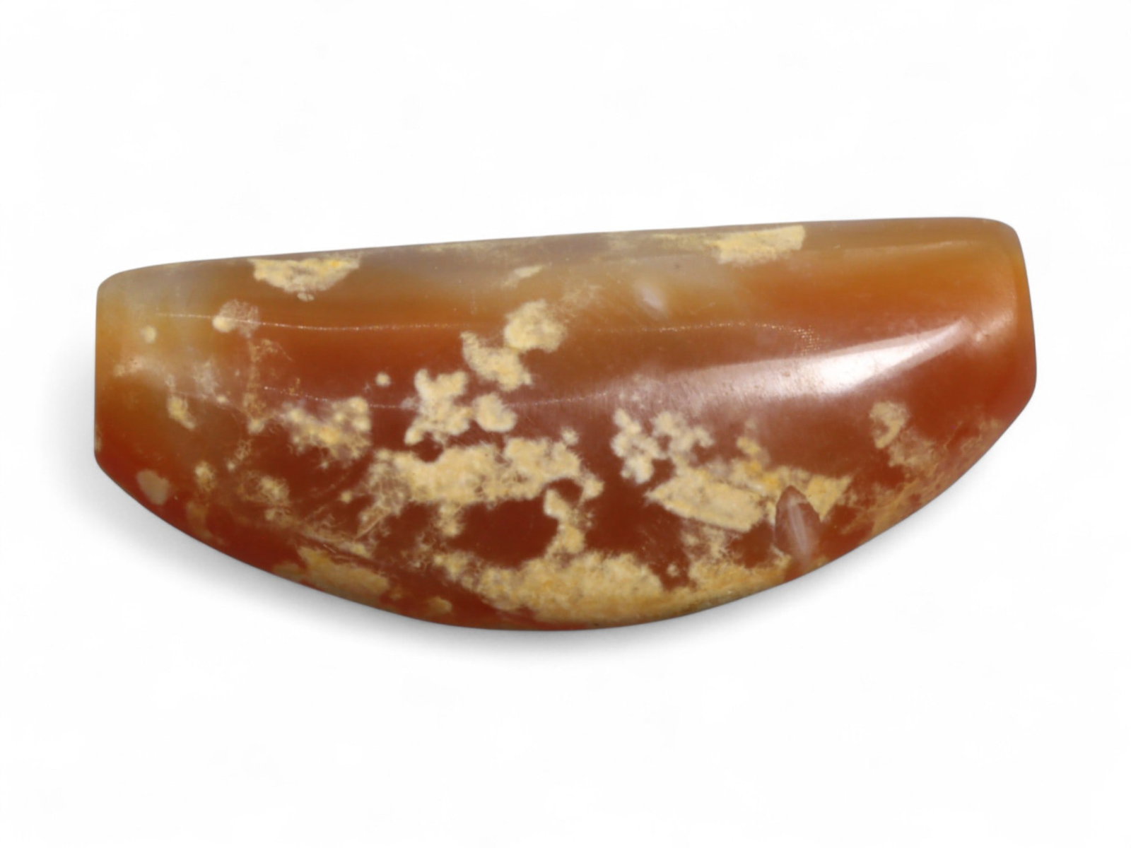 Ancient Parthian-Roman Carnelian Bow Amulet Bead, c. 1st-3rd Century CE, 3.3cm, 6g: This finely carved bow-shaped bead, is fashioned from carnelian agate with natural inclusions that lend it a mottled red-and-white surface of striking beauty. Originating from the Parthian-Roman perio