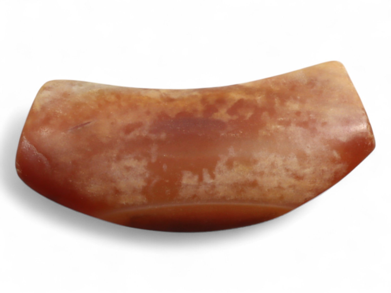 Ancient Mesopotamian Carnelian Bow-Shaped Bead, c. 2nd-1st Millennium BC, 4g: This small bow-shaped bead, carved from warm reddish carnelian, measures 2.6 cm in length and weighs 4 grams. Its smooth curvature and subtle polish reflect the refined bead-making traditions of ancie