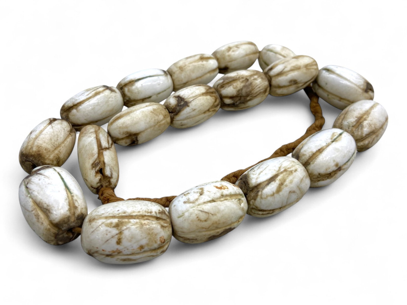 Antique Tibetan Ritual Conch-Like Bead Mala Strand, Late 19th-Early 20th Century CE, 241g: This rare and weighty strand, totaling 241 grams, is a powerful example of antique Tibetan ritual beadwork, likely used as a mala (prayer necklace) or ceremonial adornment in Bon or early Buddhist con