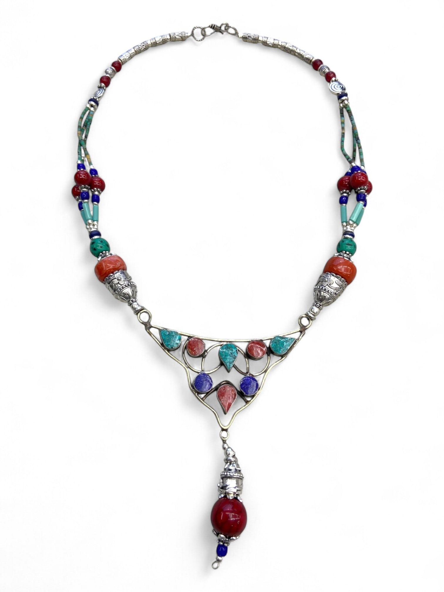 Vintage Himalayan Tribal Turquoise Coral Lapis Silver Pendant Necklace, 20th Century, 90g: This vintage Himalayan necklace captures the balance of artistry and spirituality central to the region's jewelry traditions. The triangular silver frame pendant is inlaid with turquoise, coral, and l