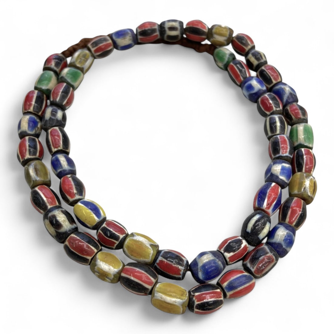 Antique Venetian Chevron Trade Glass Bead Necklace Strand, c. 19th Century, 75g: This antique strand is composed of vibrant Venetian chevron trade beads, crafted in Murano during the 19th century. Each bead displays the signature layered cane construction, with bold colors of red,