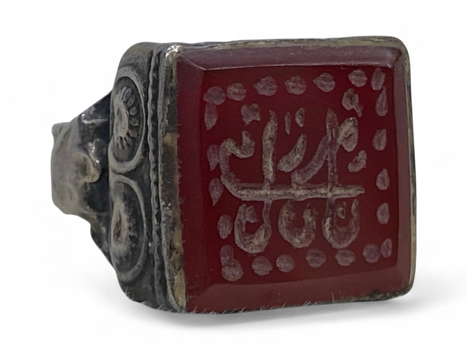 Antique Central Asian Carnelian Inscribed Silver Ring, c. 19th-20th Century, 10g: This refined antique ring features a square-cut carnelian tablet engraved with an Arabic inscription framed by dotted motifs. Inscribed gemstones were a favored form of jewelry in Central Asia and the