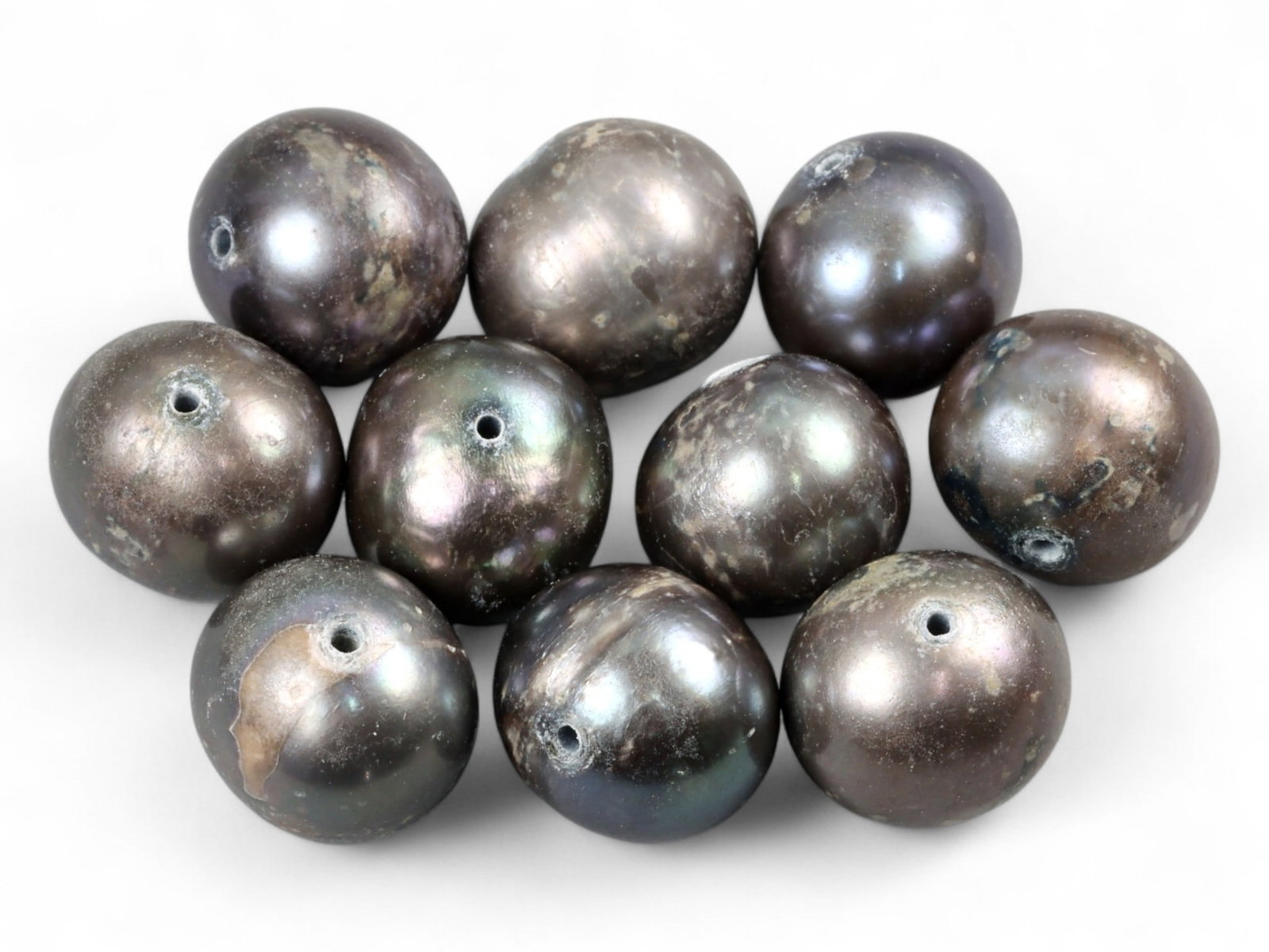 Chinese Freshwater Black Pearl Bead Lot, 8mm 8.4g: This lot of Chinese freshwater black pearls displays a mysterious, iridescent luster with overtones of violet, bronze, and green. Each pearl measures about 8mm in diameter, their drilled forms making 