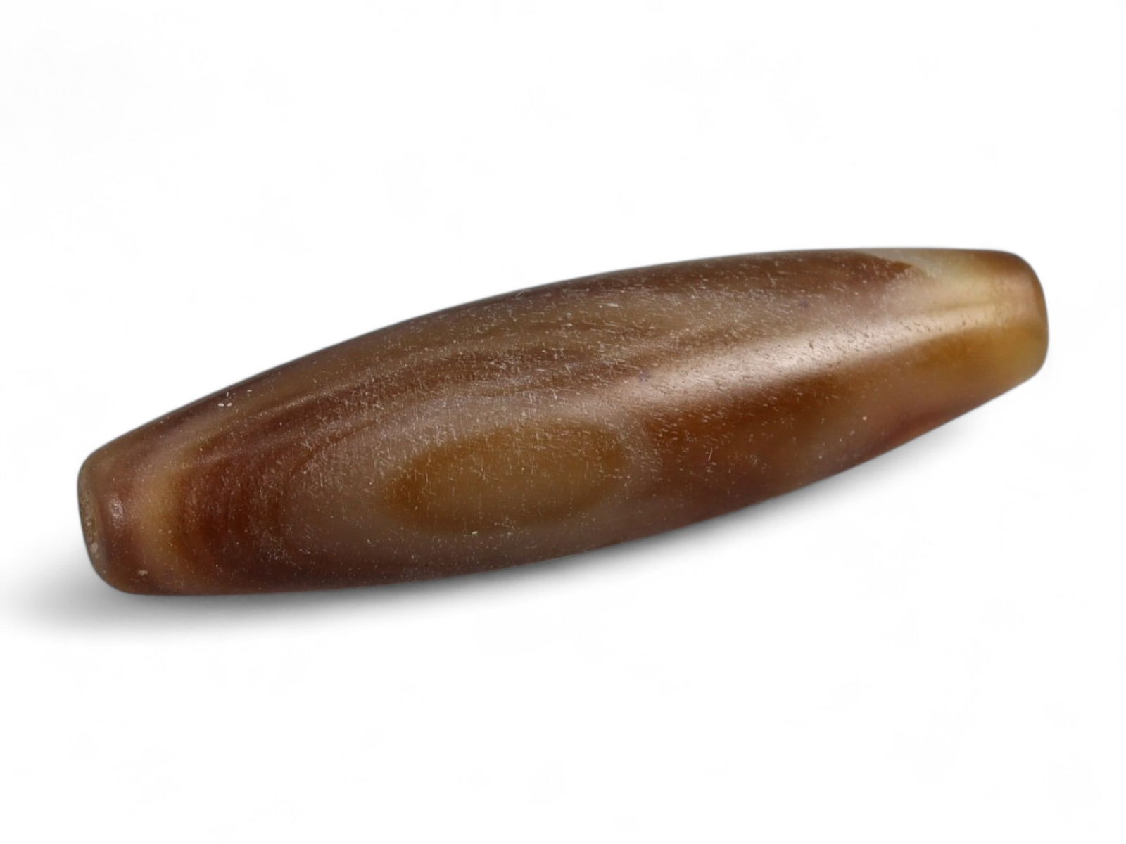 Antique Tibetan-Himalayan Banded Agate Trade Bead, 17th-19th Century, 3cm, 2.71g: This finely polished agate bead, is an elegant survivor of the vibrant Himalayan and Central Asian trade routes of the 17th-19th centuries. Its naturally occurring banded striations in soft honey, cre