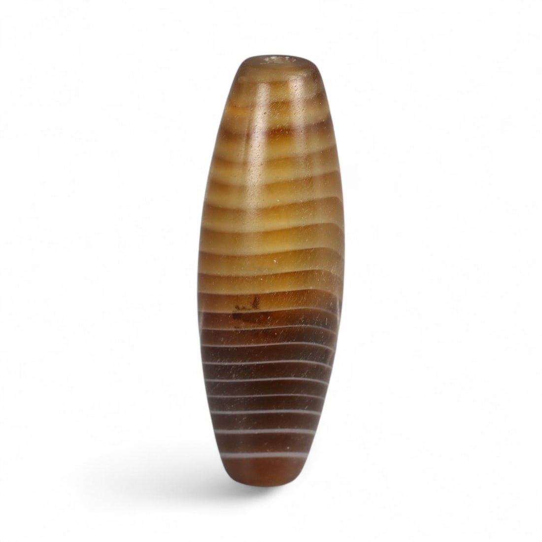 Antique Tibetan-Himalayan Banded Agate Trade Bead, 17th-19th Century, 3cm, 4.29g: This finely polished agate bead, is an elegant survivor of the vibrant Himalayan and Central Asian trade routes of the 17th-19th centuries. Its naturally occurring banded striations in soft honey, cre