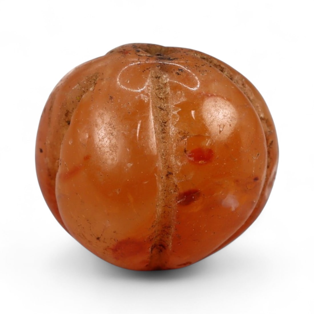 Ancient Medieval Islamic Carnelian Melon-Shaped Bead, c. 10th-14th Century CE, 1.5cm, 3.34g: This finely carved carnelian bead, measuring 1 cm, takes the form of a fluted melon, with deeply incised vertical grooves and a smooth polish. Its warm red-orange hue exemplifies the enduring appeal o
