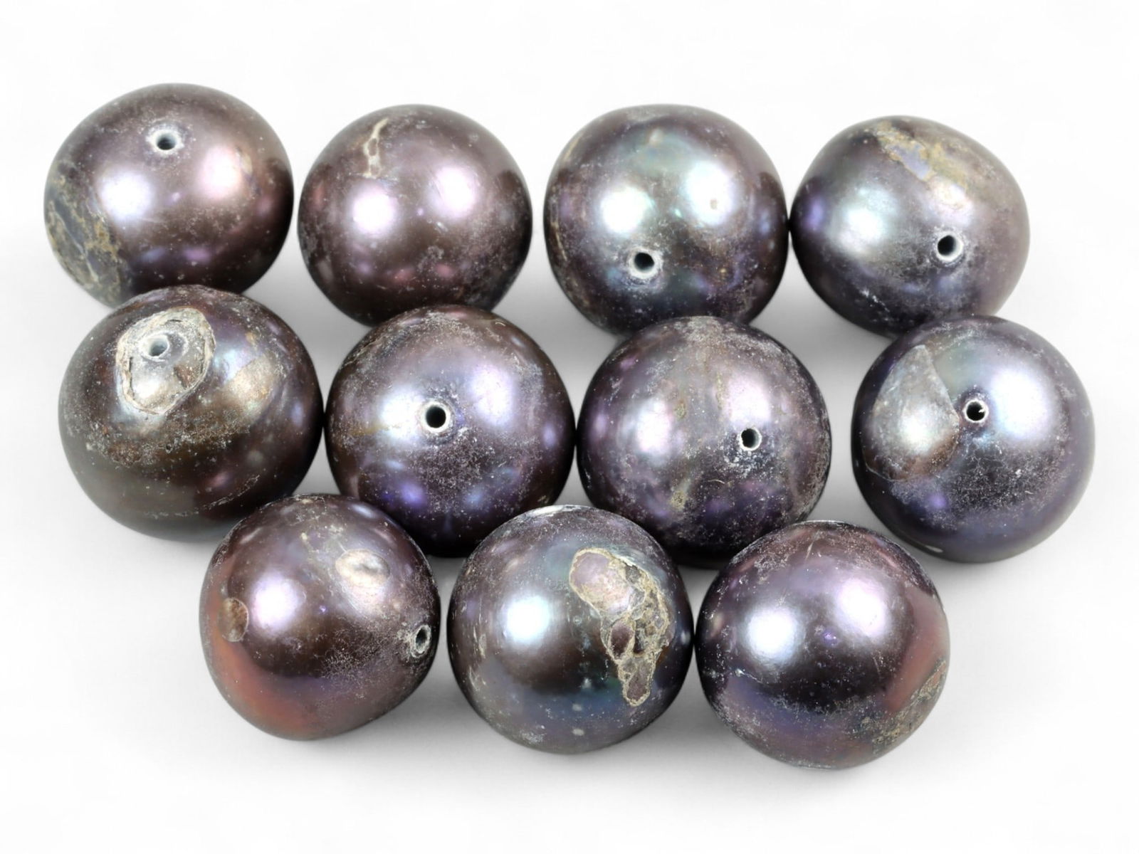 South Asian Black Freshwater Pearl Bead Lot, 9mm 14g: This refined set of black freshwater pearl beads carries an aura of natural mystery and elegance. Their deep, iridescent sheen glimmers with shades of violet, blue, and bronze, recalling the prized pe