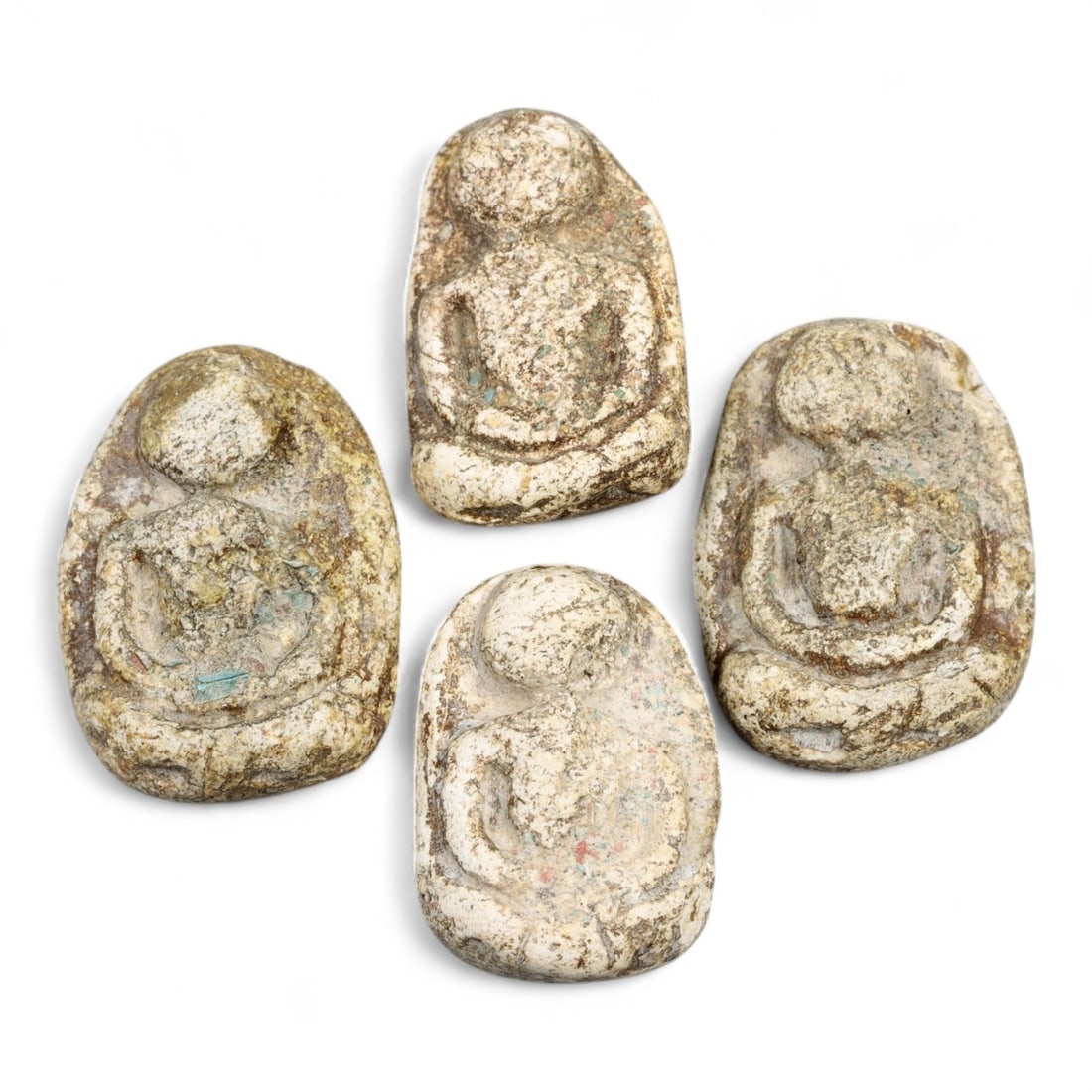 Antique Thai Buddhist Clay and Bronze Amulet Set of Four, c. Late 19th-Early 20th Century, 3cm: This remarkable set of four antique Thai amulets offers a rare glimpse into the devotional artistry and spiritual practices of Southeast Asia during the late 19th to early 20th century. Crafted in com