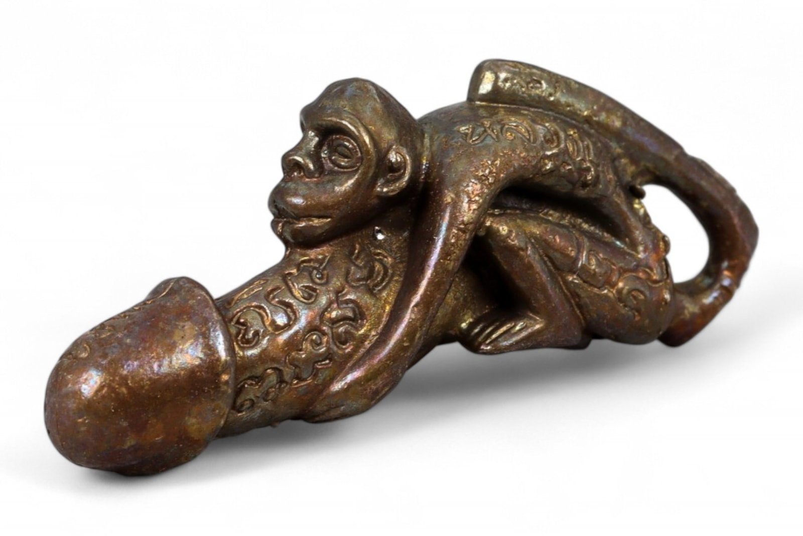 Antique Thai Lanna Hanuman Monkey Palad Khik Bronze Amulet, c. Late 19th Century CE, 17g: This striking and highly symbolic bronze amulet represents Hanuman, the legendary monkey deity of Hindu and Thai epic tradition, embracing a phallic form in the shape of a Palad Khik-a traditional Tha
