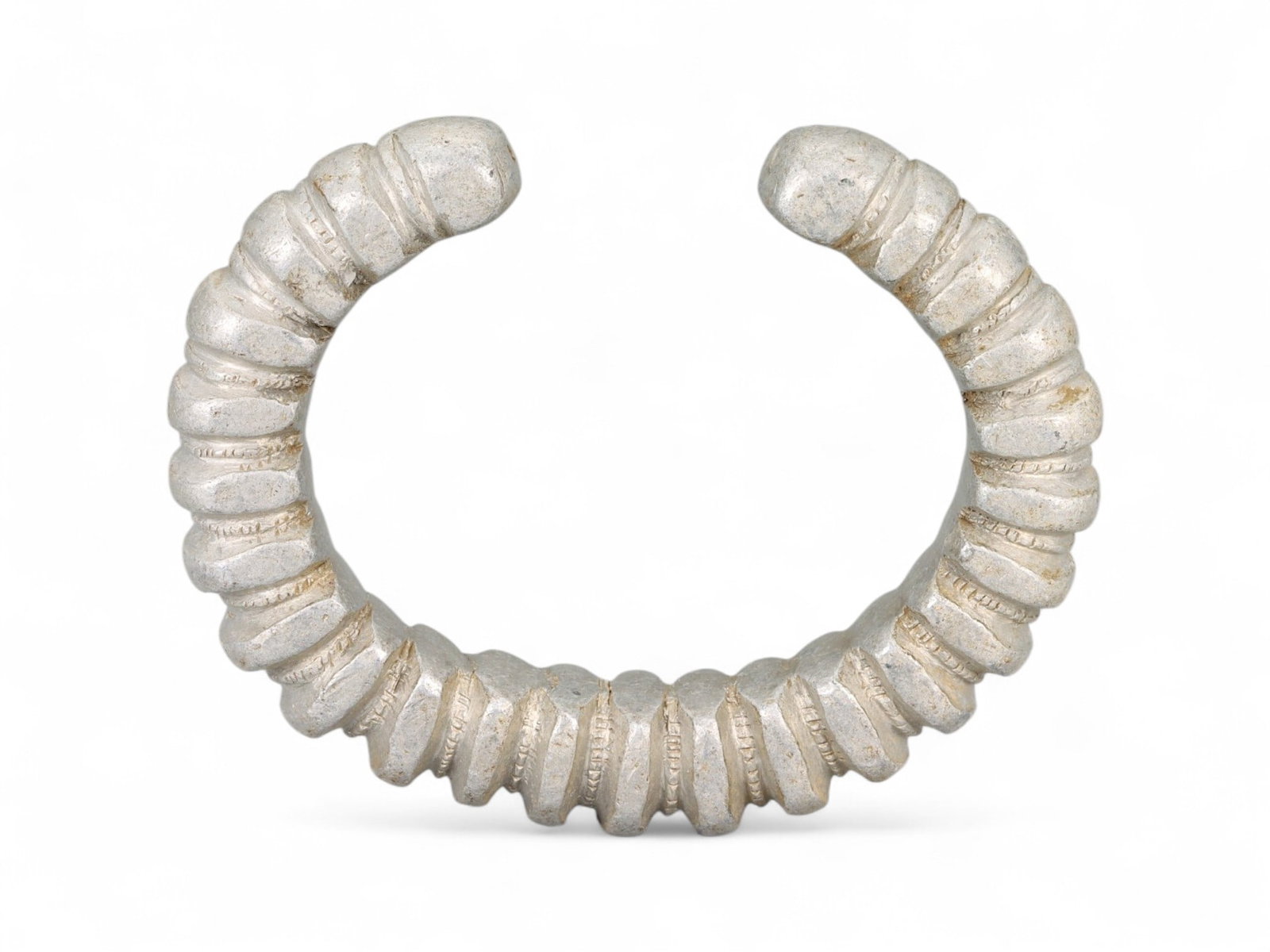 Antique West African Spiral Form Cast Aluminum Currency Bracelet, Early 20th Century, 7.7cm, 52g: This striking antique bracelet, cast in aluminum and designed in an exaggerated spiral form, represents the evolving tradition of currency adornment in early 20th-century West Africa. This piece stand