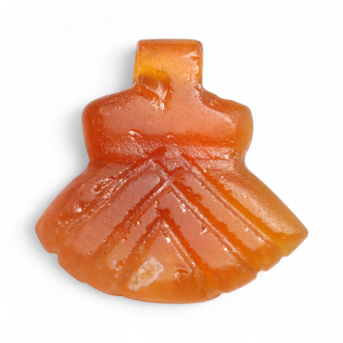 Ancient Coptic Egyptian Chevron-Robe Motif Carnelian Amulet, c. 6th-8th Century CE, 1.3g: This elegant amulet from Coptic Egypt, crafted in the 6th-8th century CE, displays a refined chevron-robe motif etched into its flared lower half. With its subtly tiered outline and incised triangular