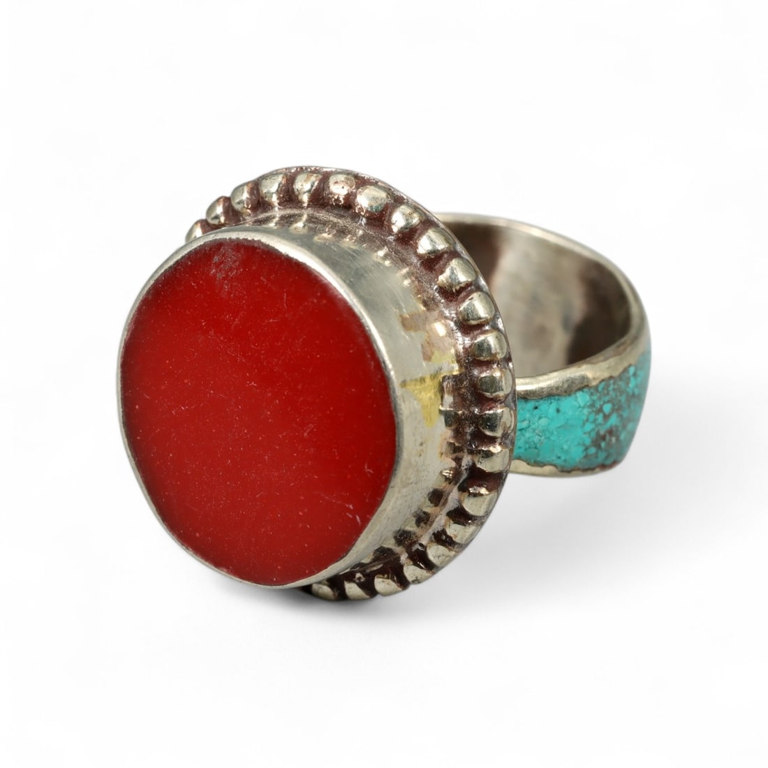 Tibetan Coral Turquoise Inlay Brass Ring with Beaded Bezel Setting, 11g: This visually arresting Tibetan ring pairs bold simplicity with sacred materials, centering on a vivid coral cabochon framed by a rounded beaded bezel and accented by turquoise inlay along the band. T