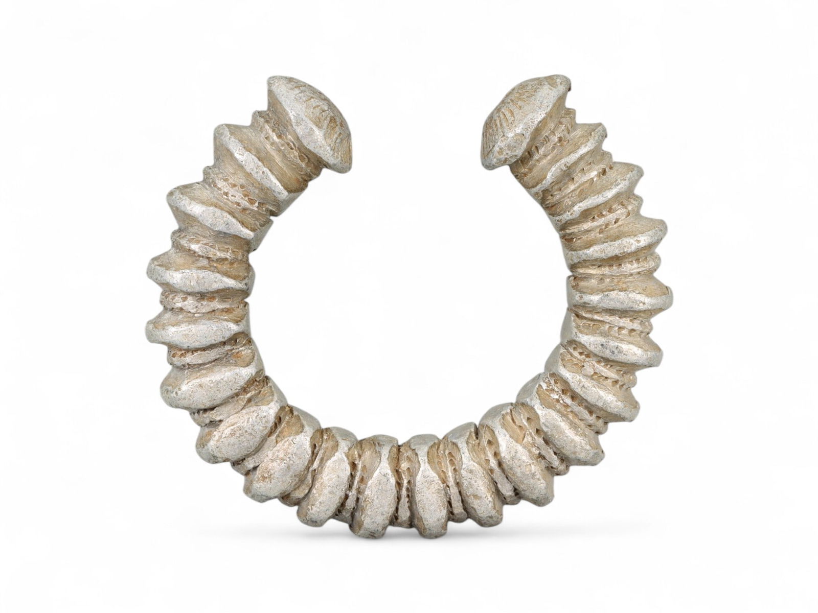 Antique West African Spiral Form Cast Aluminum Currency Bracelet, Early 20th Century, 7cm, 64g: This striking antique bracelet, cast in aluminum and designed in an exaggerated spiral form, represents the evolving tradition of currency adornment in early 20th-century West Africa. This piece stand