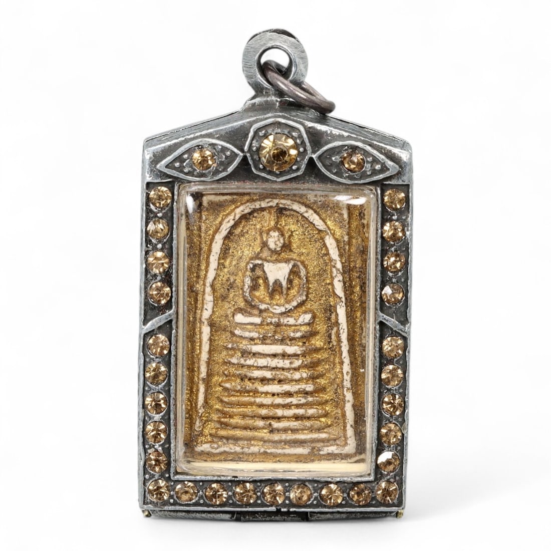 Antique Thai Somdej-Style Gilded Clay Amulet in Gemstone Frame, c. Late 19th Century, 39g: This remarkable Thai amulet embodies the revered Somdej style, one of the most sacred forms in Thai Buddhist tradition. Likely dating from the late 19th to early 20th century, this piece reflects the