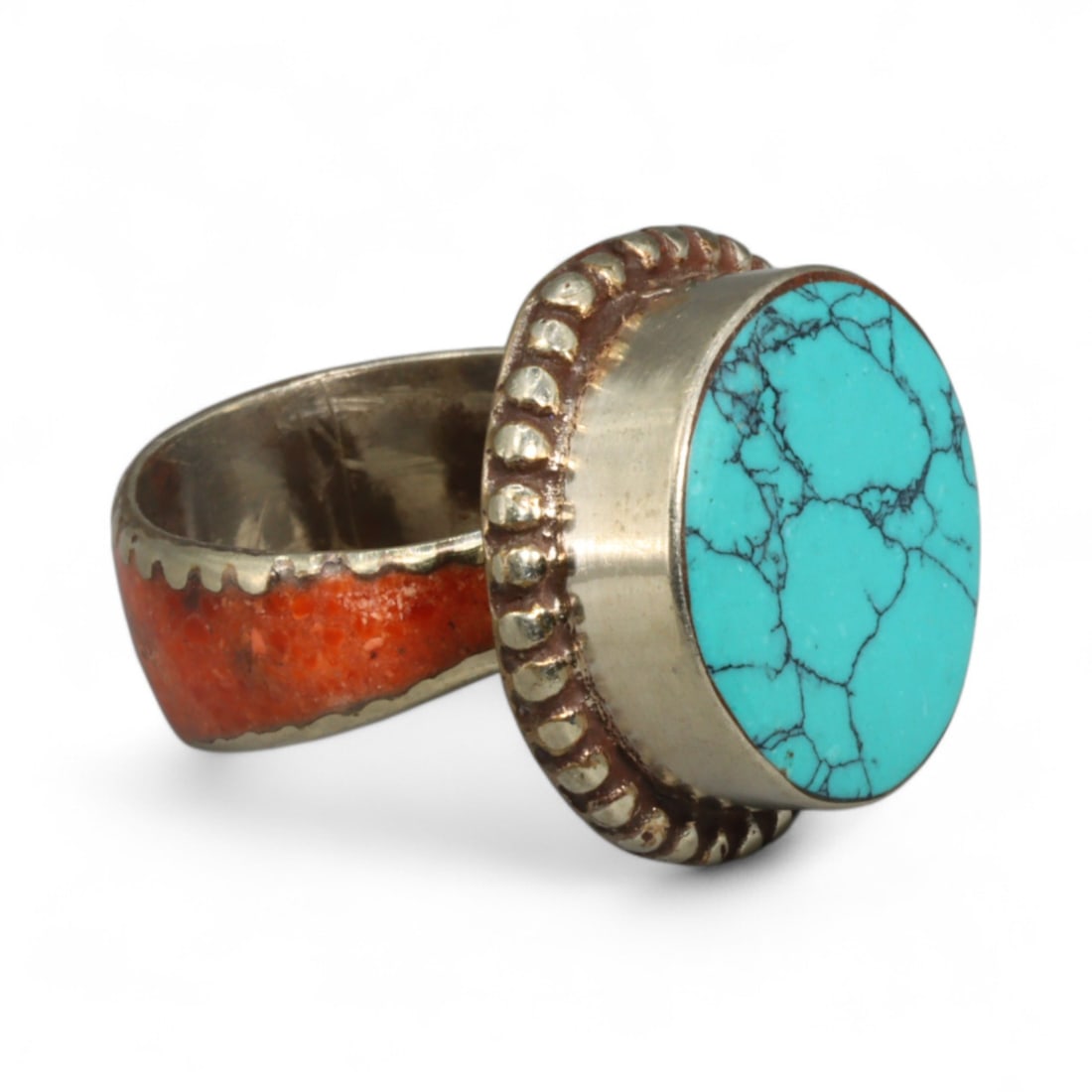 Tibetan Turquoise and Coral Inlay Brass Ring with Beaded Bezel Accent, 10g: Bold yet balanced, this Tibetan ring combines the spiritual resonance of turquoise and coral with a form that honors ceremonial craftsmanship. At its center, a large turquoise cabochon is seated withi